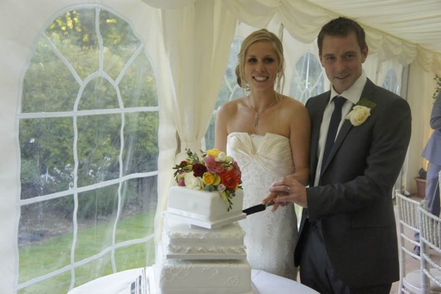 Emma and Pete cutting cake